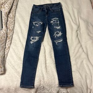 American Eagle next level stretch skinny jeans. Size 2, covered rips, navy blue